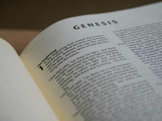 Bible open to Genesis 1:1 A Bible open to Genesis 1, where the Creation story is documented.