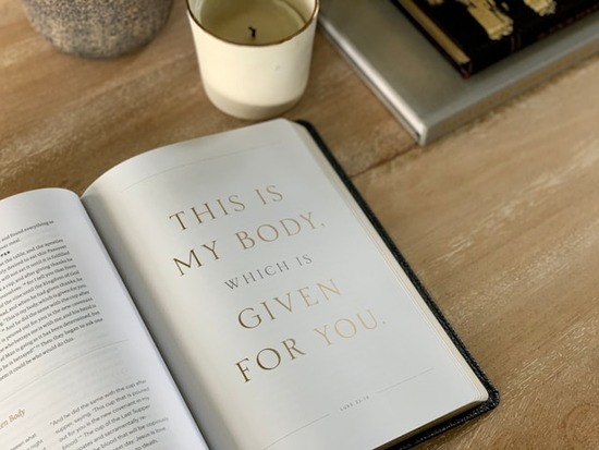  An open Bible with the verse.