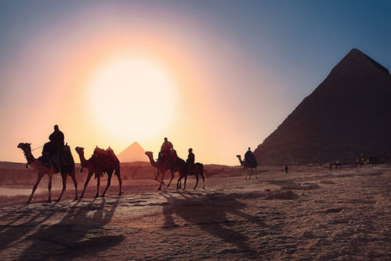 Travelers on camels near pyramids of Egypt, as we study how Joseph was sold into slavery by his own brothers.