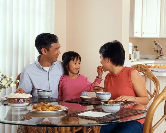 Family meal Family of three enjoying a Sabbath meal together resting.