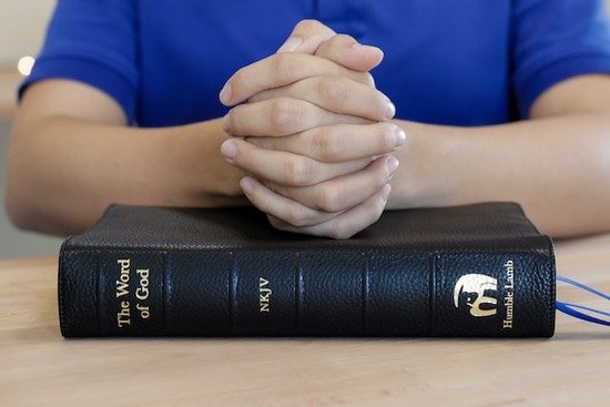 Bible Prayer Folded and Praying hands on the Bible as we explore the topic of What does the Bible say about Self control.