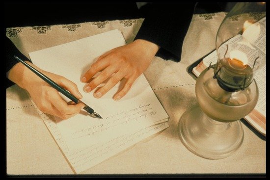 Ellen White writing by lamplight
