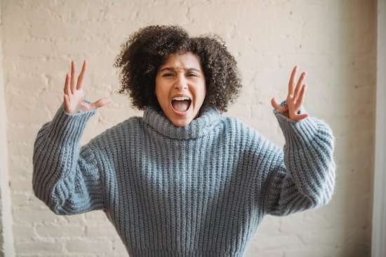 A woman with her hands up, yelling