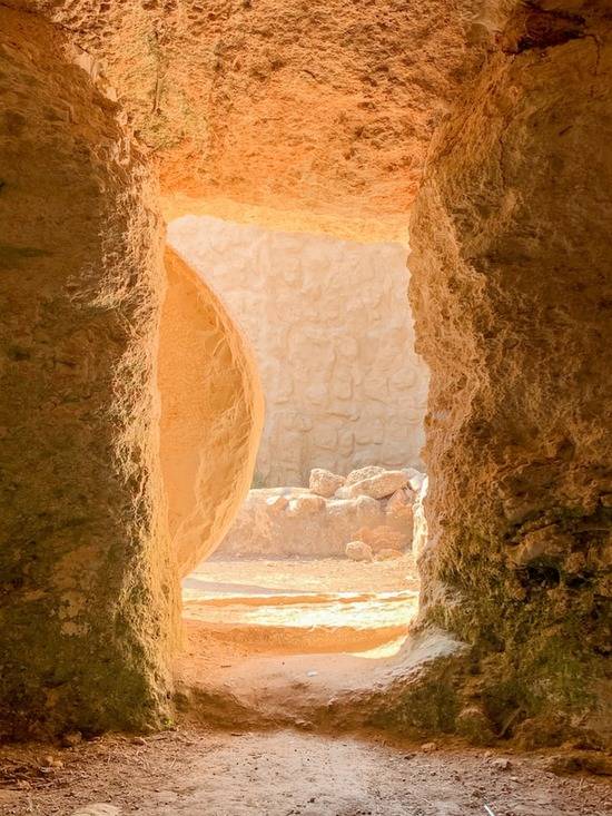 Jesus' open tomb A stone door is rolled away from the entrance of the tomb, flooding the inside of the tomb with light.