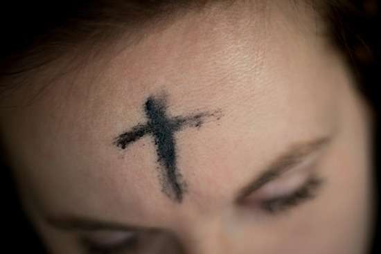 Ash Cross Forehead Lent A person with an ash cross on her forehead for Ash Wednesday