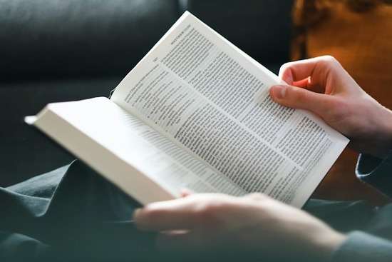  person with the Bible open to the book of Matthew