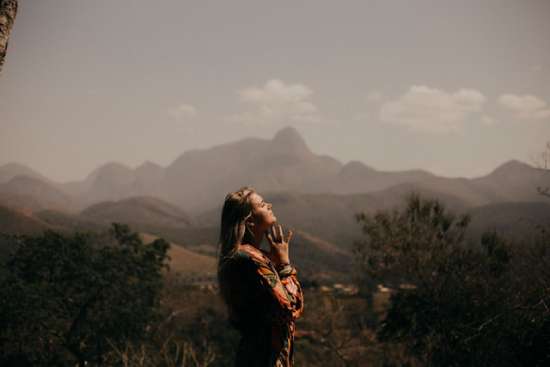 Woman outdoors showing faith A woman praying in faith to God