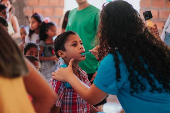 A woman provides care for a little boy, illustrating how Adventist medical missionaries can serve their communities.