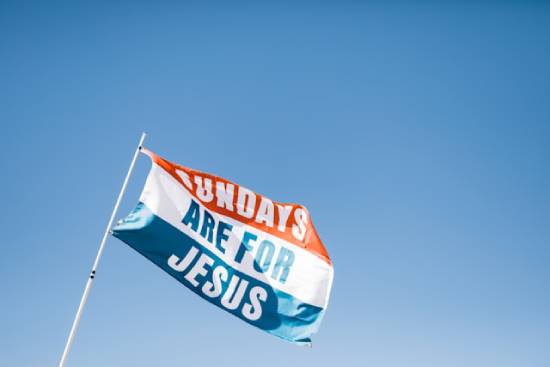 Red, white, and blue flag that says Sundays are for Jesus A flag saying, "Sundays are for Jesus."