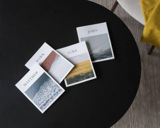 Four separate Gospel books on a black table Four separate books with the name of a different Gospel on each sit on a black table, representing the importance of understanding the similarities and differences between them.