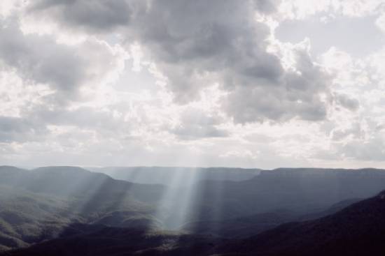 Sunbeams peeking through the clouds in the sky