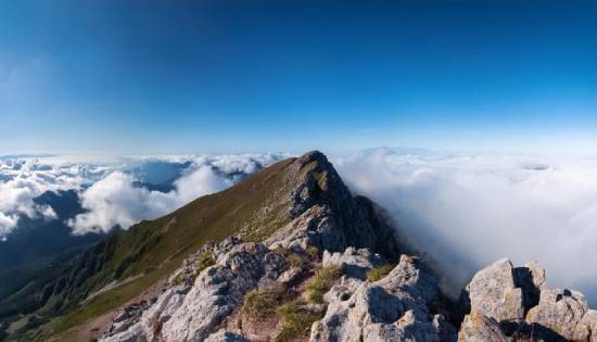 A mountain peak poking through the clouds