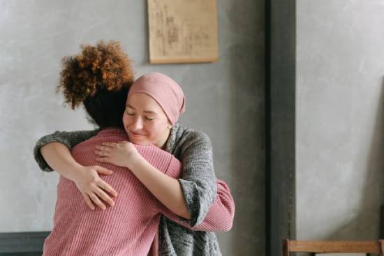 Two friends hugging to show their love and support Two friends lovingly embrace.