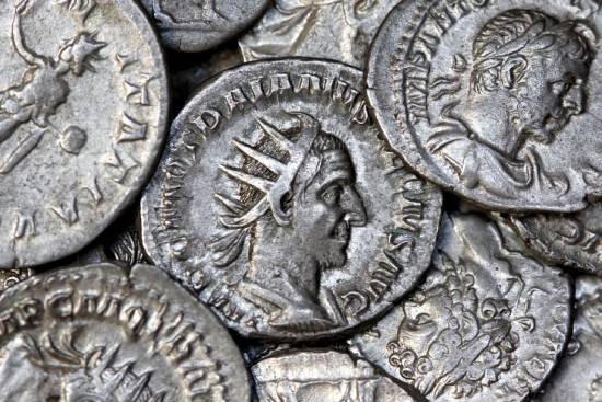 A close-up view of several silver Roman coins