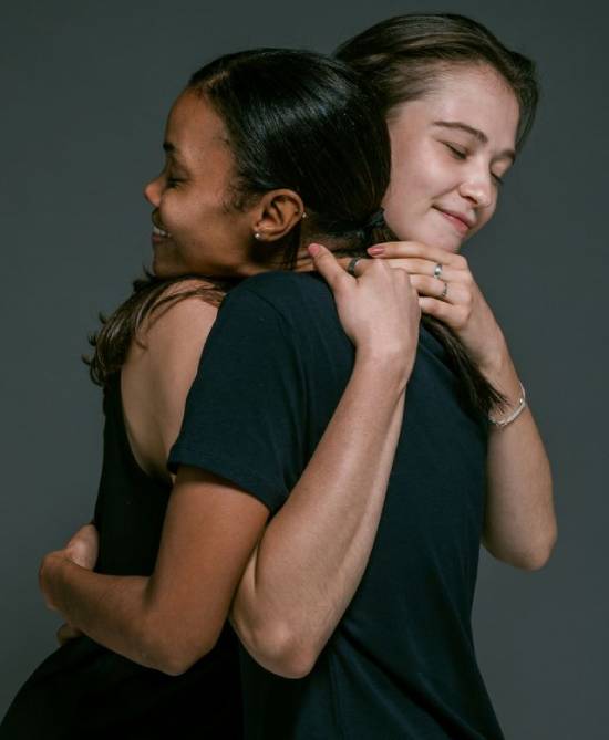 Two women hugging and healing their relationship Two women hugging in reconciliation
