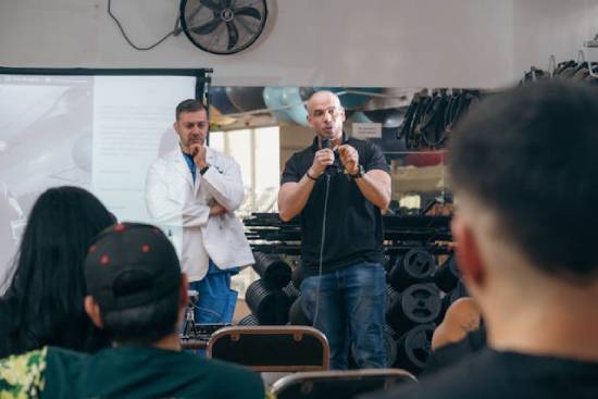 A man gives a presentation in front of a small audience.