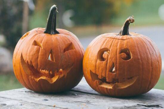 Two pumpkins carved into jack-o-lanterns for Halloween, a holiday that many Adventists don't celebrate