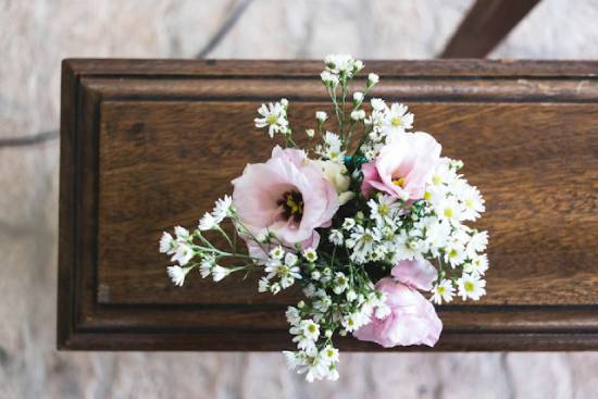 Flowers sit on top of closed casket.